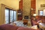 The stone, gas log fireplace will keep you toasty